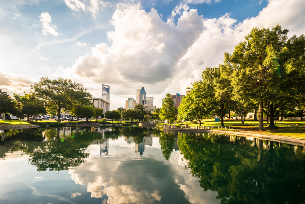 A park and pond with the city skyline in the background in Charlotte, North Carolina.
