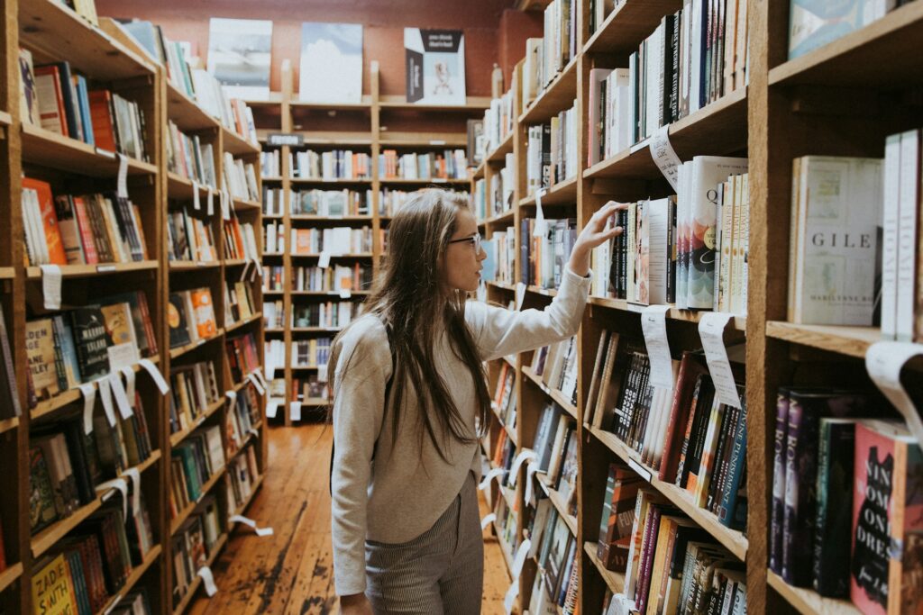 Young girl checking out books at a book shop