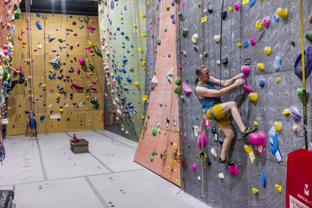 Man rock-climbing indoors